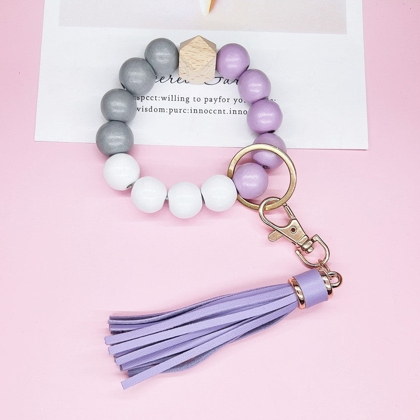 Llavero de muñeca con borla de cuentas de silicona de imitación de madera al por mayor